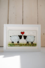 Load image into Gallery viewer, Framed artwork of two sheep with a red heart in the centre in a green field. Mounted in an oblong frame. Handmade by Flow Glass Orkney Islands 
