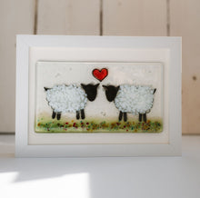 Load image into Gallery viewer, Framed artwork of two sheep with a red heart in the centre in a green field. Mounted in an oblong frame. Handmade by Flow Glass Orkney Islands 
