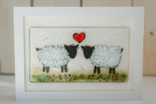 Load image into Gallery viewer, Framed artwork of two sheep with a red heart in the centre in a green field. Mounted in an oblong frame. Handmade by Flow Glass Orkney Islands 
